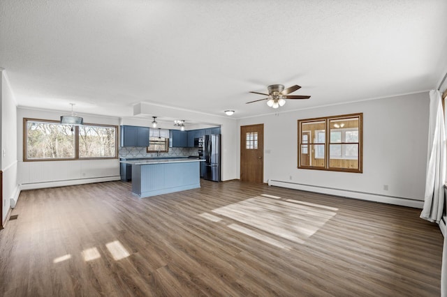 unfurnished living room featuring baseboard heating, ornamental molding, and dark hardwood / wood-style flooring