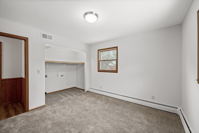 unfurnished room featuring a baseboard radiator and light colored carpet