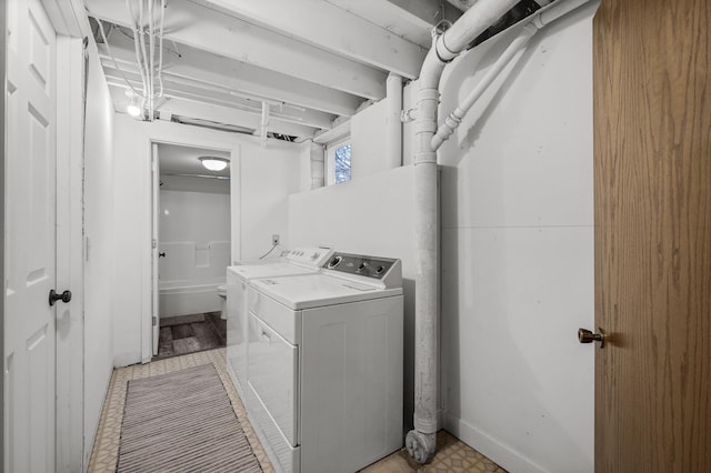 clothes washing area with separate washer and dryer