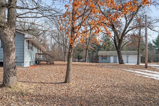 view of yard with a garage and an outdoor structure