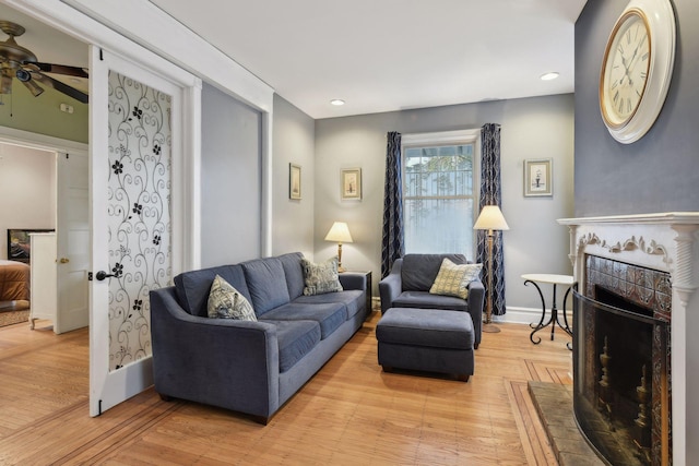 living room featuring ceiling fan and light wood-type flooring