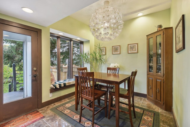 dining space featuring plenty of natural light and an inviting chandelier