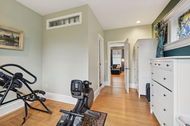 workout room featuring light wood-type flooring