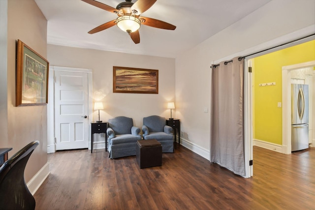 sitting room with dark hardwood / wood-style floors and ceiling fan