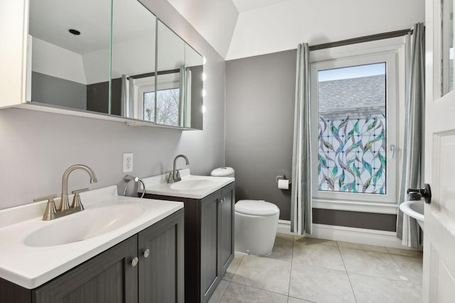 bathroom featuring tile patterned floors, plenty of natural light, vanity, and toilet