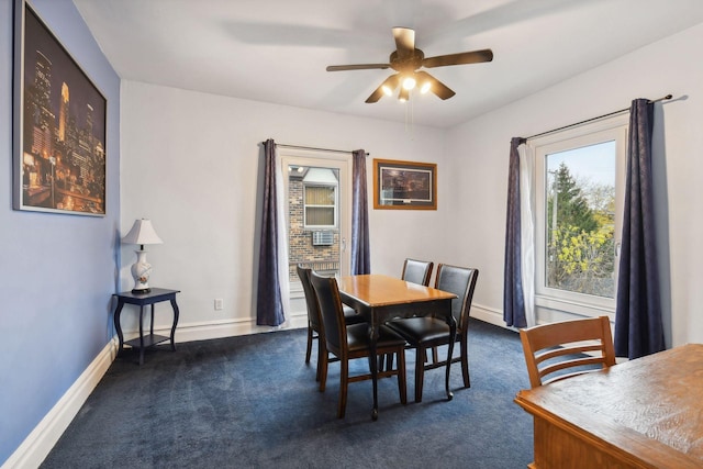 dining area featuring ceiling fan and dark carpet