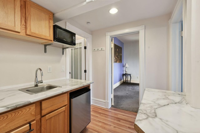 kitchen featuring dishwasher, light stone countertops, sink, and light hardwood / wood-style flooring