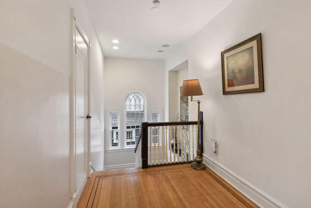 corridor with hardwood / wood-style floors