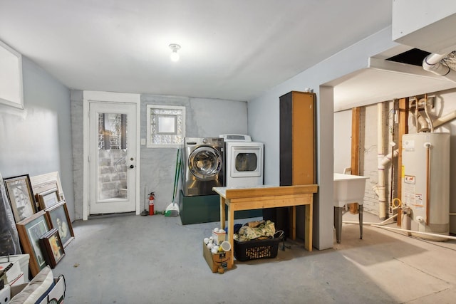 clothes washing area with gas water heater and washing machine and dryer