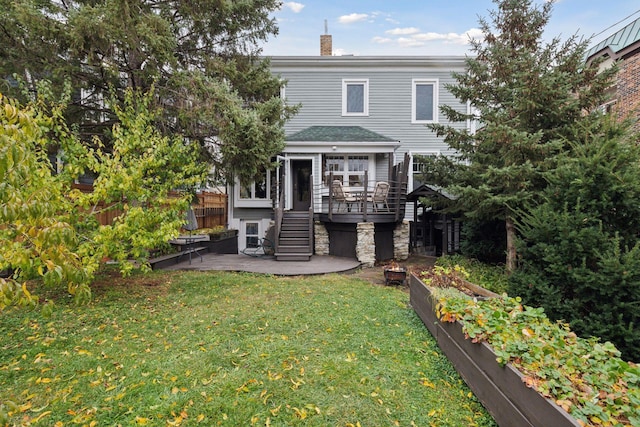 rear view of property with a lawn, a patio, and a deck