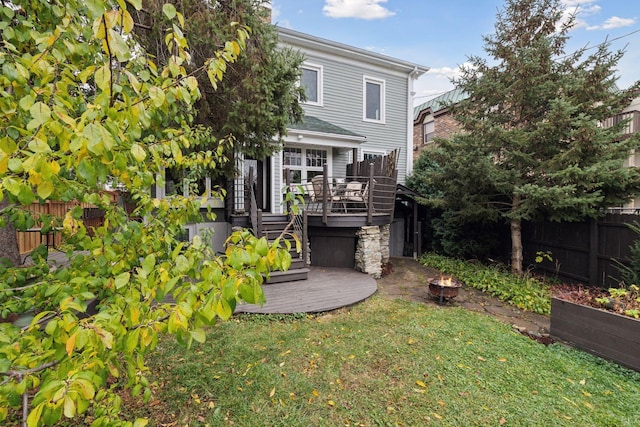 back of property featuring a yard and a deck