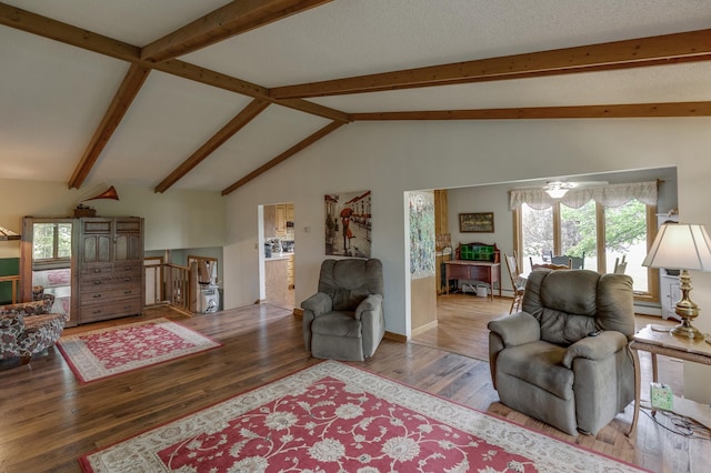 living room featuring lofted ceiling with beams, a baseboard heating unit, and wood finished floors