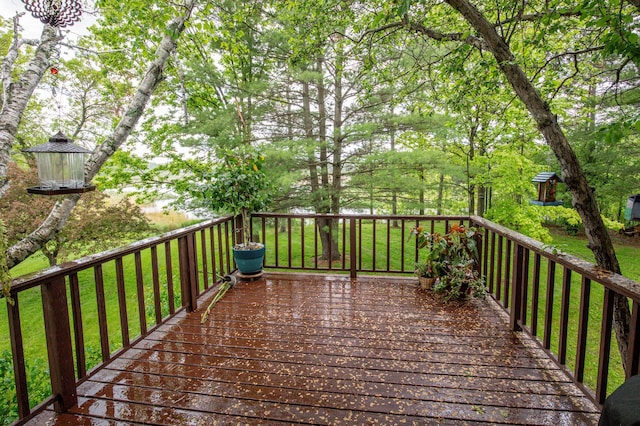 wooden terrace with a lawn