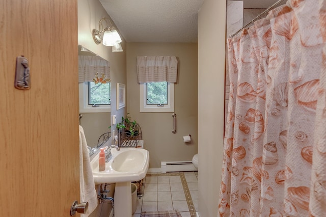 full bathroom with a textured ceiling, tile patterned flooring, toilet, a baseboard heating unit, and baseboards