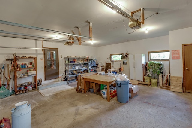 garage with a garage door opener and freestanding refrigerator