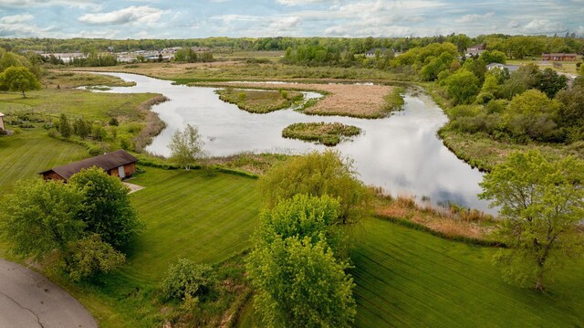 birds eye view of property featuring a water view and a rural view