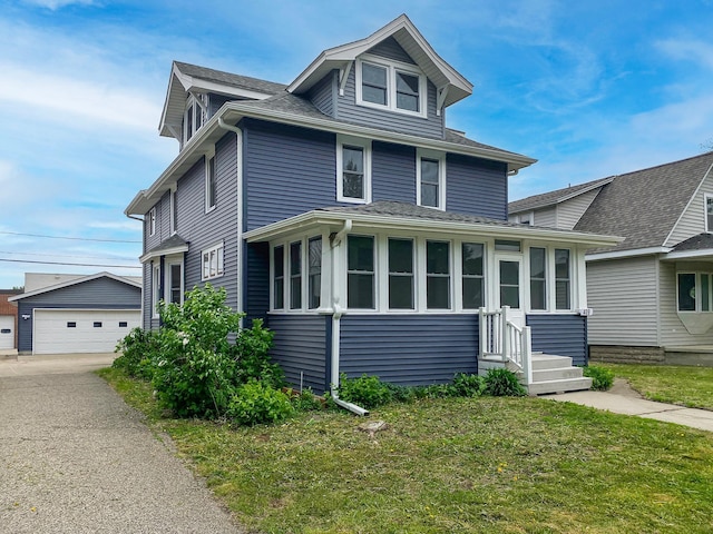409 Adams St, Arlington, MN 55307 - traditional style home with entry steps, an outdoor structure, a garage, a front lawn, and a shingled roof