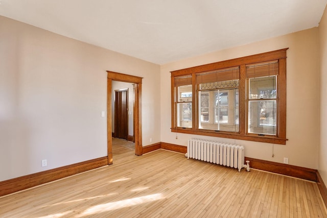 409 Adams St, Arlington, MN 55307 - empty room featuring radiator, baseboards, and light wood-type flooring