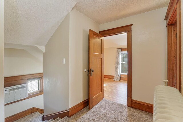 409 Adams St, Arlington, MN 55307 - hallway with a textured ceiling, baseboards, and a wall mounted AC