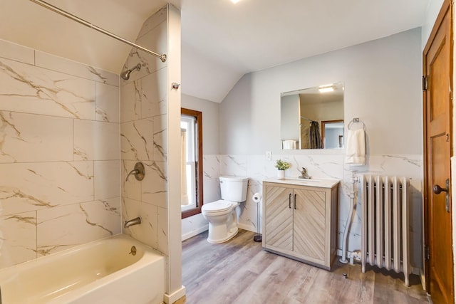409 Adams St, Arlington, MN 55307 - full bath featuring radiator, toilet, vaulted ceiling, vanity, and wood finished floors