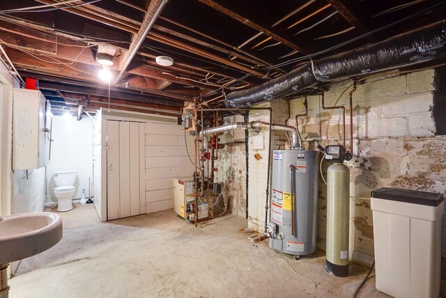 409 Adams St, Arlington, MN 55307 - unfinished basement with gas water heater, a heating unit, a sink, and a water softener