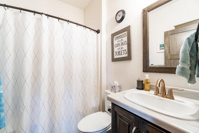 bathroom with vanity, a shower with shower curtain, and toilet