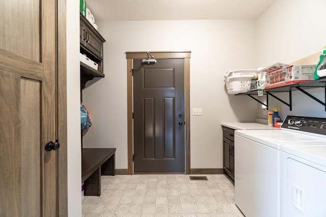 laundry area featuring cabinets and separate washer and dryer