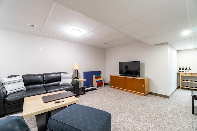 living room featuring a drop ceiling and carpet floors