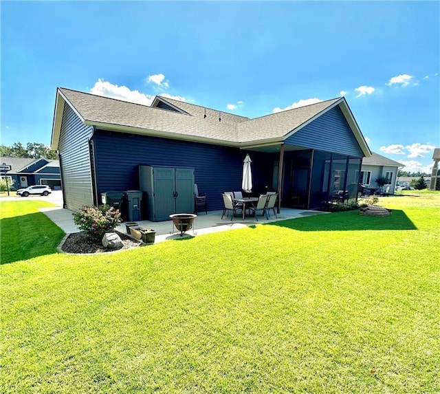 rear view of house with a patio and a lawn