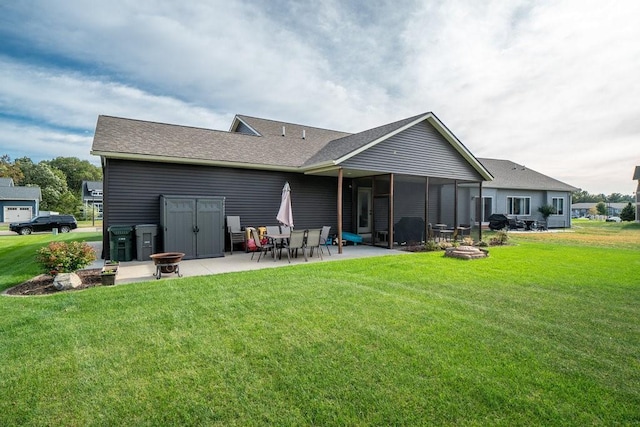 rear view of house featuring a lawn, a patio area, and a sunroom