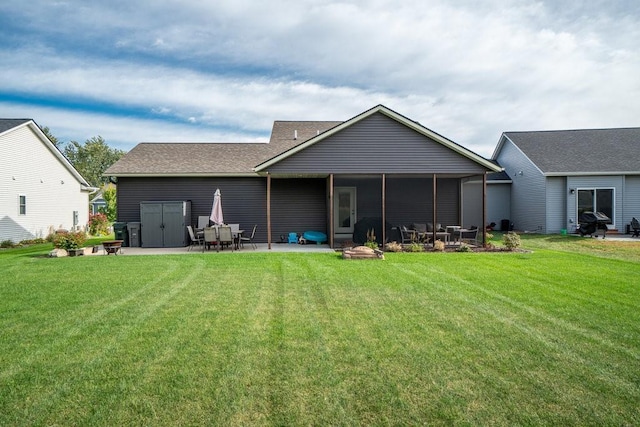 back of property with a sunroom, a yard, and a patio