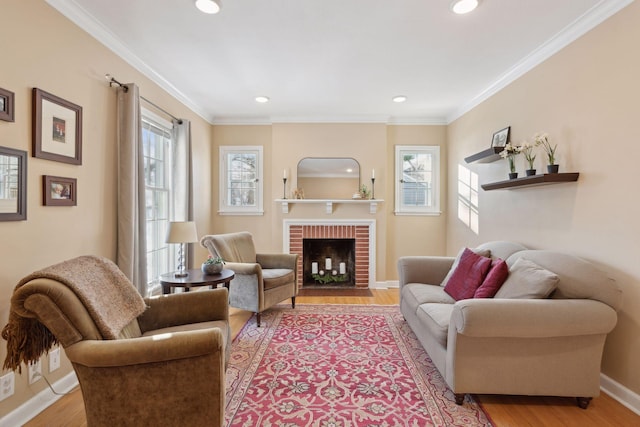 living room featuring ornamental molding, a fireplace, and light wood-type flooring