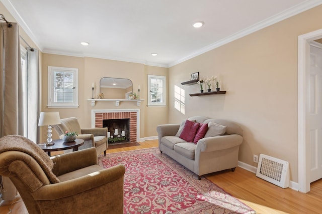 living room featuring a fireplace, crown molding, and wood-type flooring