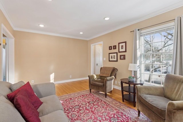 living room with ornamental molding and light hardwood / wood-style floors