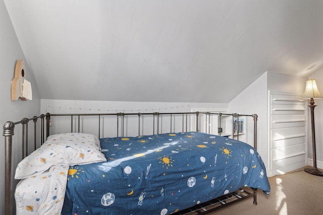 carpeted bedroom with lofted ceiling