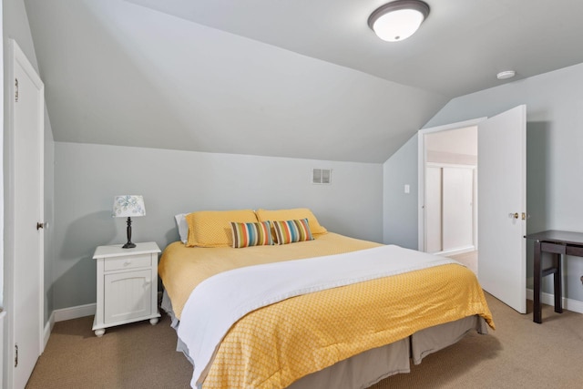 carpeted bedroom with vaulted ceiling