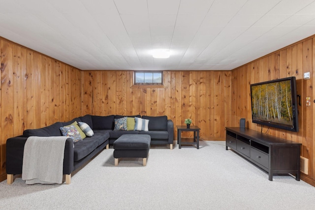 carpeted living room with wooden walls