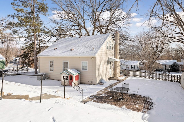 view of snow covered rear of property