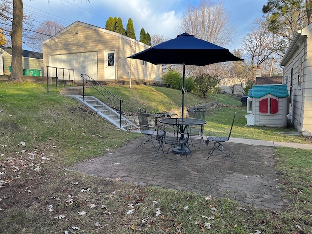 view of yard with a storage unit, a patio, and a garage