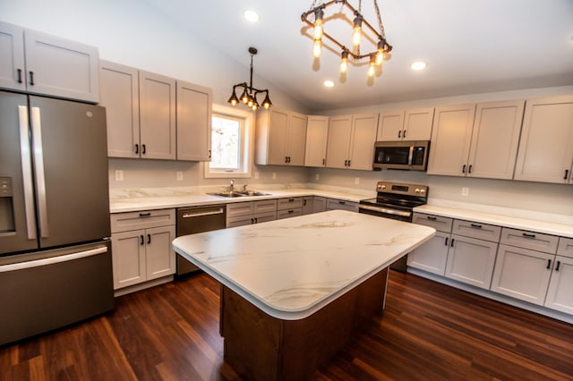 kitchen featuring dark wood finished floors, stainless steel appliances, recessed lighting, gray cabinetry, and vaulted ceiling