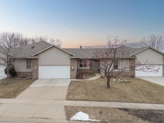 single story home featuring a yard and a garage