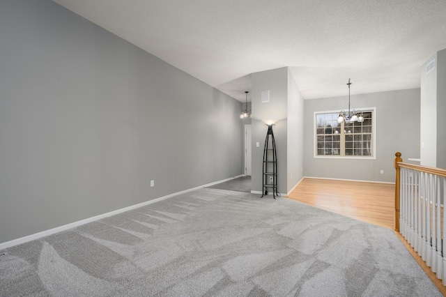 unfurnished living room with a chandelier and light colored carpet