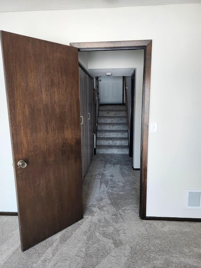 corridor with dark colored carpet