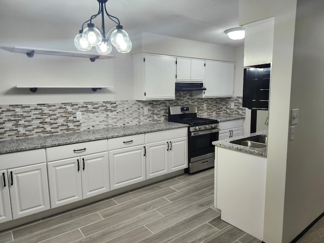 kitchen with sink, stainless steel range with gas cooktop, white cabinetry, tasteful backsplash, and pendant lighting