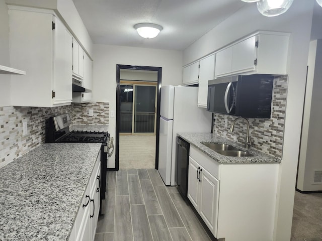 kitchen with white cabinets, black dishwasher, gas stove, and sink