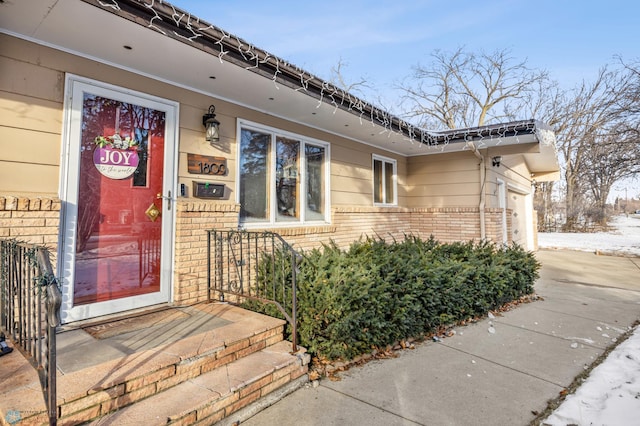 doorway to property with a garage