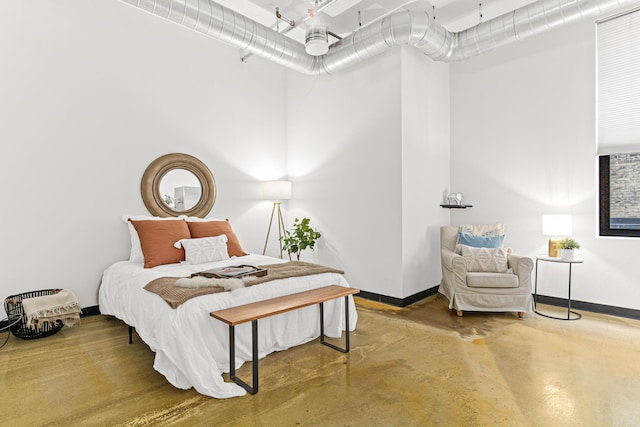 bedroom with ceiling fan and concrete floors