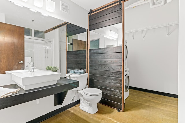 bathroom with hardwood / wood-style floors, toilet, sink, and walk in shower