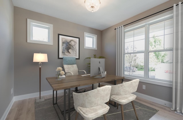 office area with baseboards and light wood finished floors