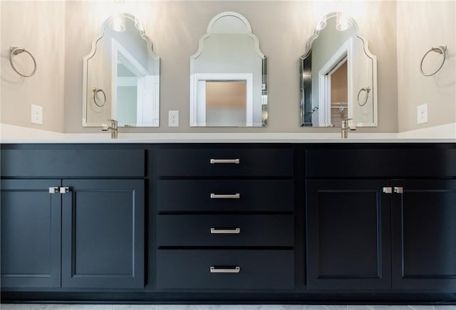 full bathroom with a sink and double vanity